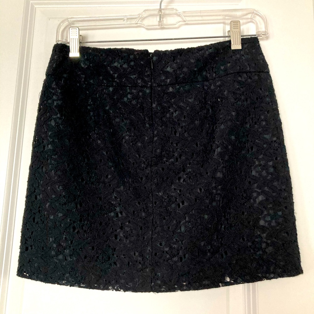 Black mini skirt with laser cut design over lining